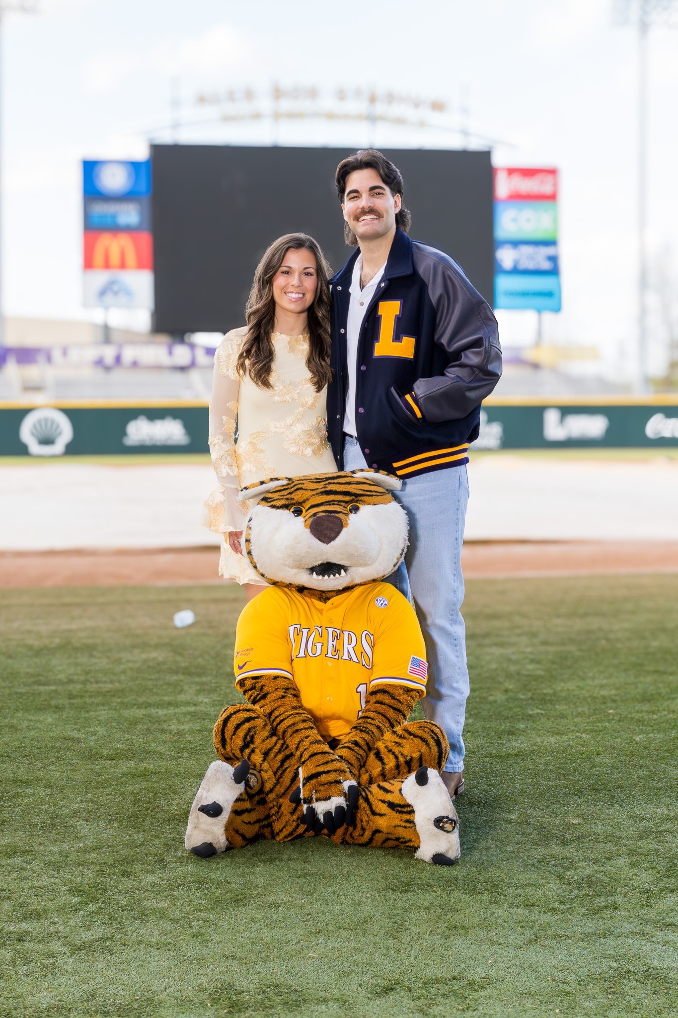 Landon Terro poses with his girlfriend on the field at Alex Box Stadium alongside Mike the Tiger during a graduation photo session. Landon Terro poses with his girlfriend on the field at Alex Box Stadium alongside Mike the Tiger during a graduation photo session.