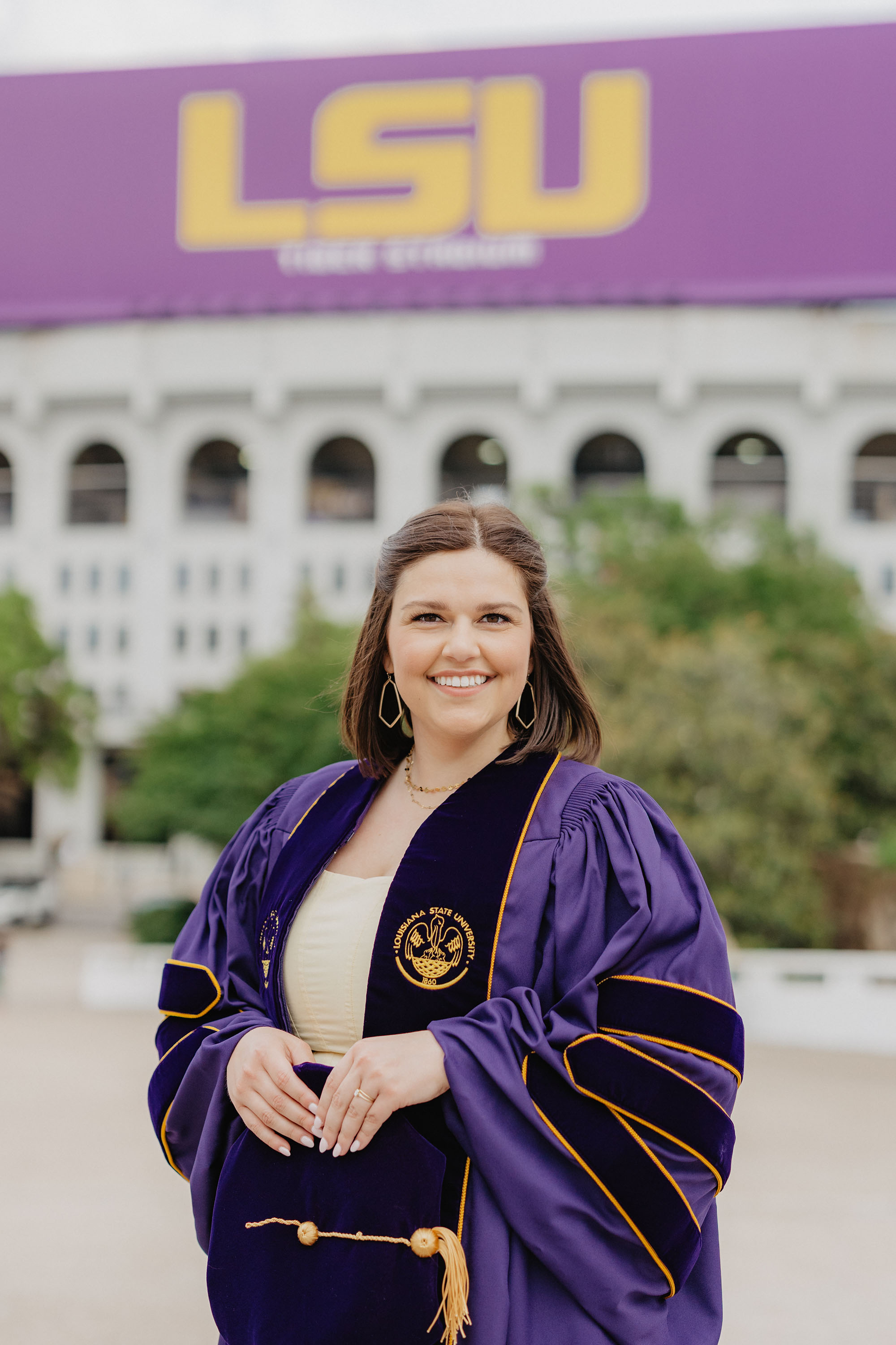 Hannah Stark in cap and gown on LSU campus