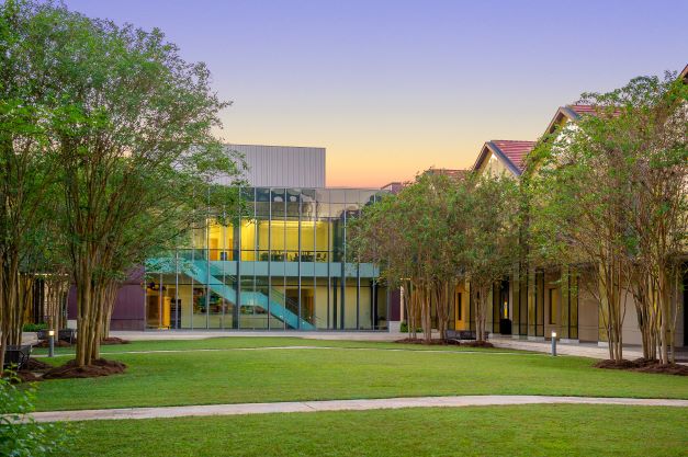 Viewed from the BEC Courtyard, the auditorium glows against the twilight sky.