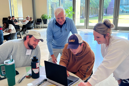 Photo of students working in a group with a mentor from the food industry