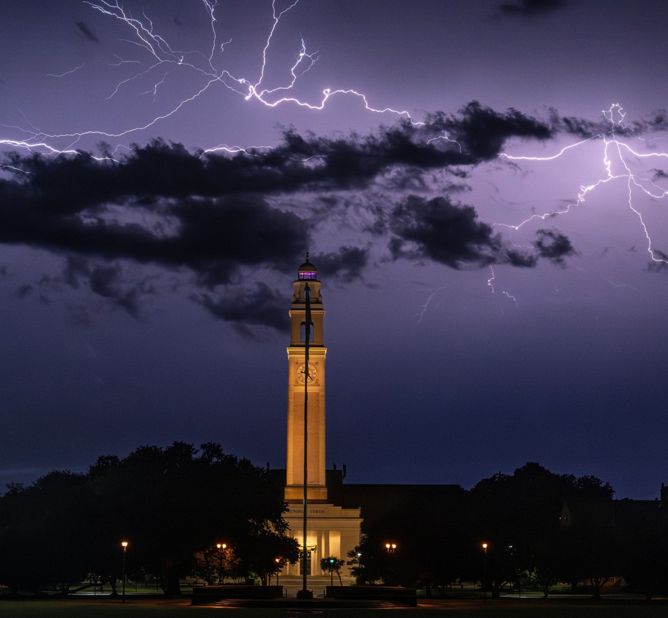 lightning strikes behind the LSU clock tower