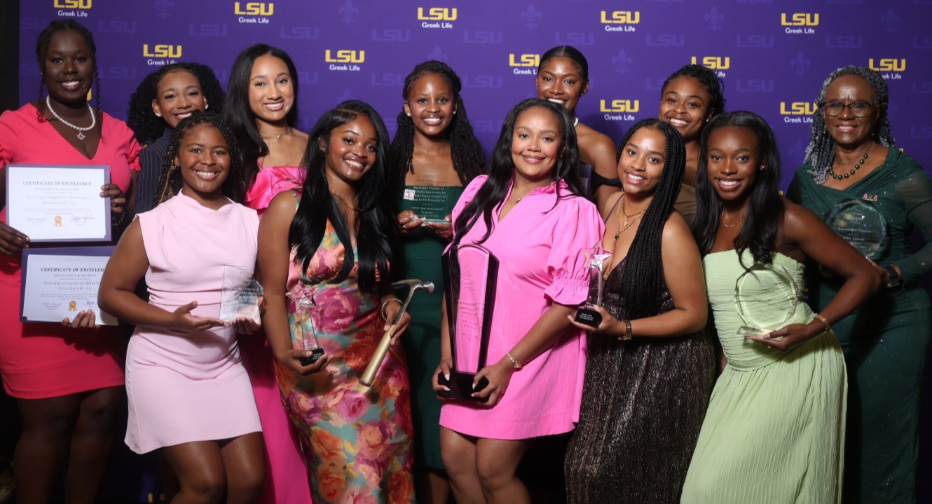 women of aka pose with award
