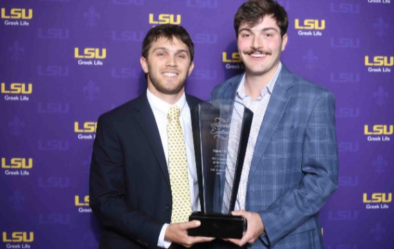 sigma chi members pose with award