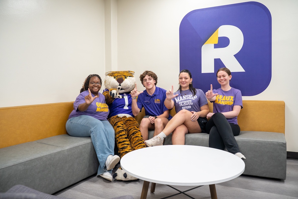 Students sitting with Mike the Tiger mascot Students sitting with Mike the Tiger mascot