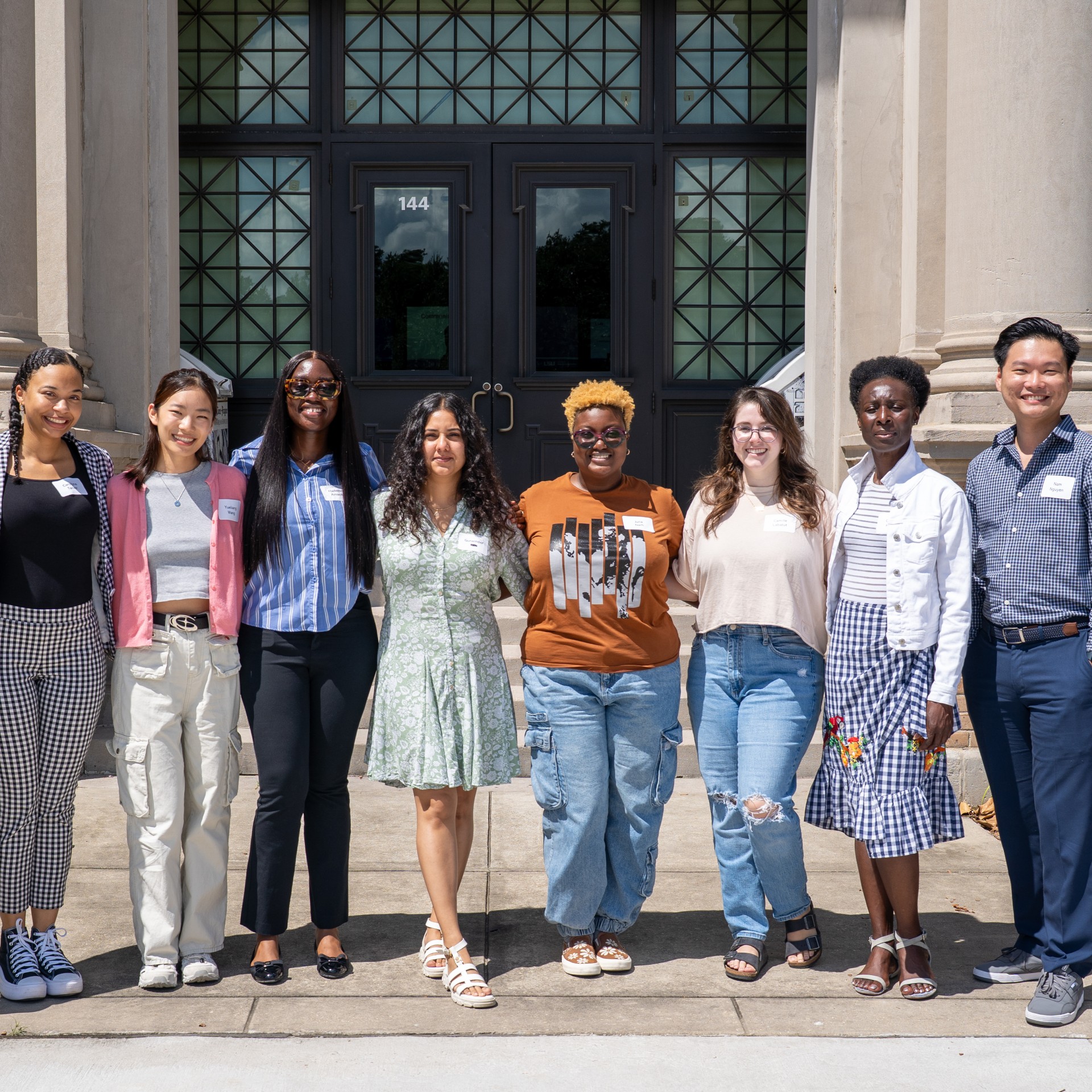 A group image of PhD students in front of the Journalism building