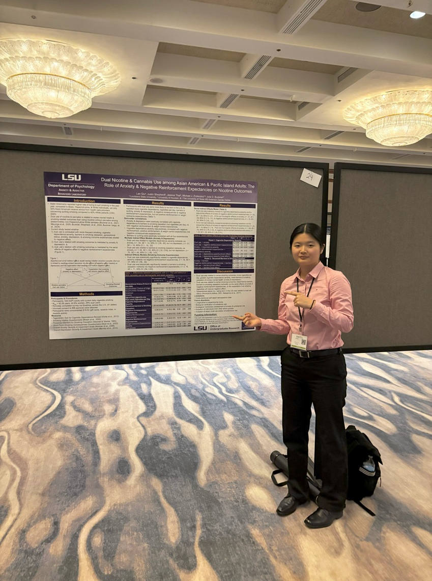 Student presenting a research poster at a conference