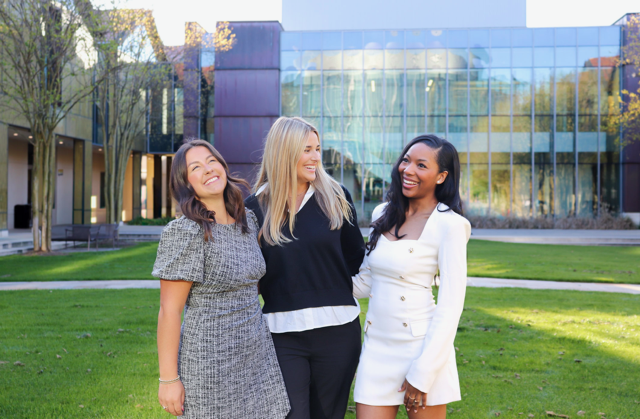 three student government members smiling at the camera