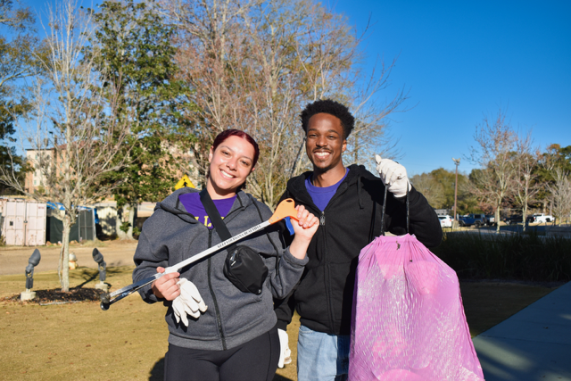 two students holding bags for clean up two students holding bags for clean up