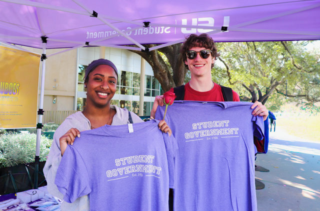 student government members posing with shirt